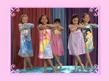 The ethnically diverse plain girls show off Disney Princess nightshirts in the rehearsal stage of the Dance Along feature.
