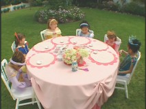 Girls dressed as Disney princesses gather round the table for Princess Craft Time!