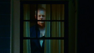 Here's something you don't want to see in spying on your neighbors: the creepy Mr. Turner (David Morse) stares back at his uneasy audience.