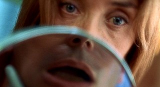 Two faces come together as one when physical therapist Marie (Olatz Lopez Garmendia) coaches Jean-Do with a mirror reflecting his mouth.