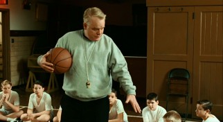 Father Flynn (Philip Seymour Hoffman) shows the students on the school basketball team his clean fingernails. He likes to keep them a little long.