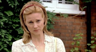 Behind a cross necklace and a usually bright smile, Laura Linney assumes an English accent and plays the evil mother.