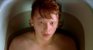 Our shy hero shot -- shirtless Rupert Grint enjoys a quiet bath.