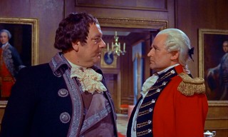 King George III (Eric Pohlmann) expresses his displeasure in General Pugh's (Geoffrey Keen) unsuccessful efforts to nab the Scarecrow.