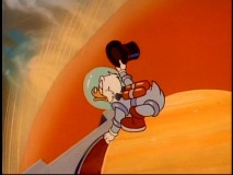 Scrooge recreates a Dr. Strangelove scene as he rides his money bin back to earth.