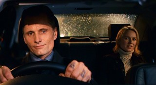 With tattoos by his knuckles, Nikolai (Viggo Mortensen) the "driver" gives Anna a ride home.