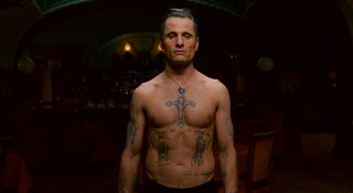 Nikolai shows off his tattooed body, the calling card of a Russian criminal, to a group looking to give him some new body art. If you think this is revealing, it's nothing compared to what the studio calls Viggo Mortensen's "now infamous steam room fight scene"!