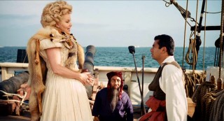Worlds from two live-action Disney blockbusters come together as the White Bitch (Jennifer Coolidge) appears with diminutive henchman Bink (Tony Cox) on Captain Jack's pirate ship.