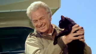 Eddie Albert shares a joyous moment with the kids' winking black cat Winky.