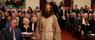 All eyes in Congress turn towards Evan as he makes a bold fashion statement with his robe, cloak, and crazy hair.