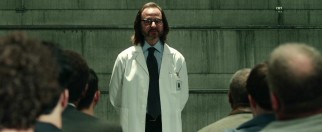 Archaleta (Fisher Stevens) welcomes the volunteers to their new home for the next two weeks and carefully lays out the guidelines that must be followed.