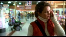 Aileen (Keri Russell) telephonically questions her husband's actions, while Megan acts out in the background of this deleted shopping scene.