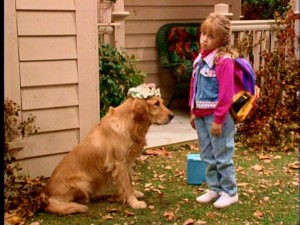 While she's no longer the only cute, young one, Michelle still receives a considerable amount of attention in the part now needlessly shared by Mary-Kate and Ashley Olsen. Here, she passes on her headwear to Comet the dog.