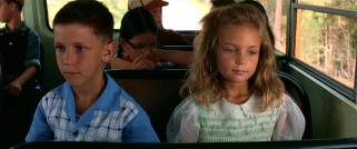 On his first day of school, young Forrest Gump (Michael Conner Humphreys) finds a friend and a seatmate in Jenny Curran (Hanna Hall).