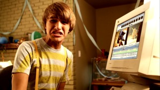 Fred Frigglehorn (Lucas Cruikshank) hesitates before uploading a video to the Internet, something that may or may not reflect the habits of the teenaged boy who created the character in a similar way.