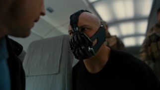 The bald, masked baddie Bane (Tom Hardy) is introduced early on as the film's primary villain.