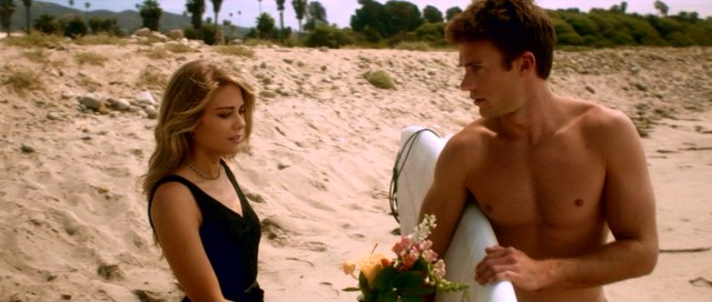 The combination of flowers, sun, a surfboard, and shirtlessness does not lift the spirits of Donna (Kim Matula) and John (Scott Eastwood).