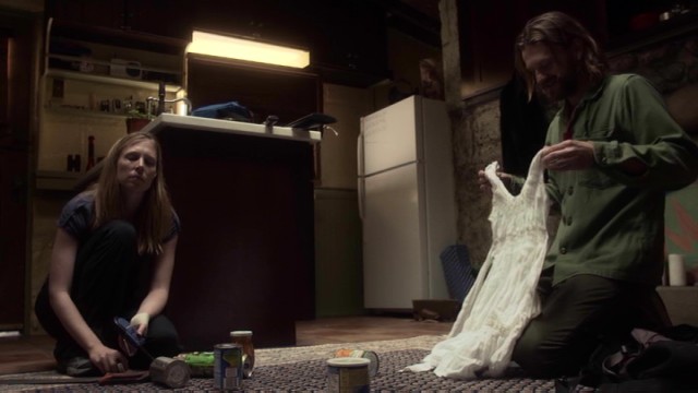 Kim (Amy Cale Peterson) isn't as excited as Mike (Dean Chekvala) by the white dress he just found.