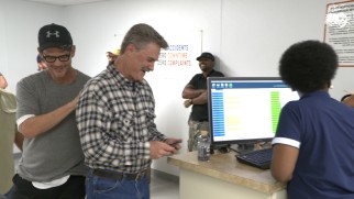 Kurt Russell checks his phone while director Peter Berg gives him a pat on the back in "Beyond the Horizon."