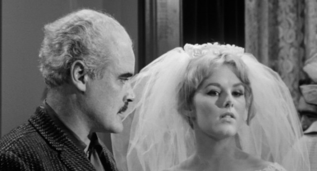 Kane (Mary Mitchel) gets schooled by family doctor Justin Caleb (Patrick Magee).