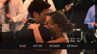 The terrifying main menu applies glitches to the couple's wedding video.