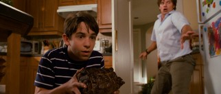 Greg Heffley (Zachary Gordon) and his father (Steve Zahn) use Mom's pot roast to lure the family's new dog Sweetie away from Manny's blanket Tingy.