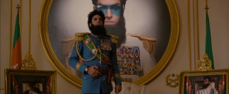 Admiral General Aladeen (Sacha Baron Cohen) stands proudly in a room designed to his specifications.