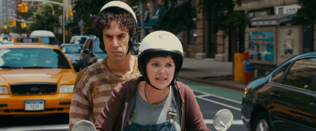 Taking Aladeen (Sacha Baron Cohen) for a dissident, bleeding heart liberal Zoey (Anna Faris) gives him a ride on her Vespa.