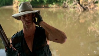 The man known as both "The Cajun" and Bob Logan (Rib Hillis) multi-tasks, taking a phone call while waiting for a reptile to respond to the blood he just shed in the Louisiana bayou.