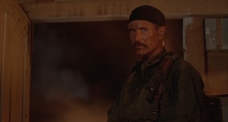 As the mustachioed Drew Blakeley, Tom Berenger makes a fatal mistake in the film's West African climax.