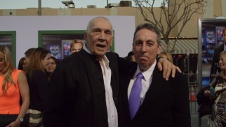 A Kevin Costner cardboard standee photobombs Frank Langella and director Ivan Reitman at the Draft Day premiere.