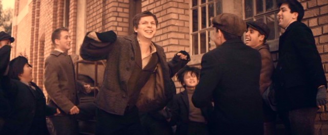 Morris Cohen (Michael Cera) does some celebratory dancing following the newsboy strike of 1899.