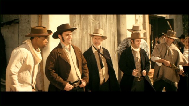 William B. Travis (Jake Johnson), Jim Bowie (Chris Parnell), and Davy Crockett (Derek Waters) defend the Alamo against Santa Ana in "The Wild West."