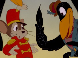 Crow leader Jim Crow presents Timothy Q. Mouse with the "magic" (wink, wink) feather that will help Dumbo fly.