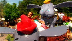 A CG-animated Dumbo flies up behind a father and daughter taking his ride of passage in a short piece on the popular Fantasyland attraction.