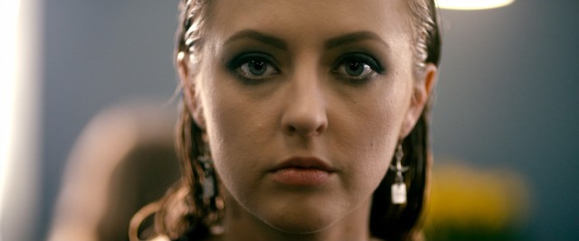 This shot of a blank-eyed, fugue state Flamingo (Katharine Isabelle) opens and closes the film and has the end credits scroll down it.
