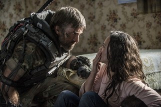 Mercenary Agent Kruger (Sharlto Copley) questions Frey (Alice Braga), a life-long friend who offers Max medical assistance.