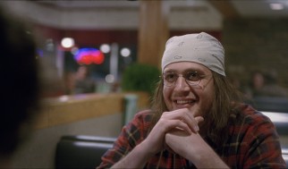 Jason Segel sports long hair, glasses, and a bandanna as David Foster Wallace.
