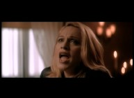 Madonna sings in the "You Must Love Me" music video.