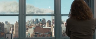 At work, Mrs. Schell (Sandra Bullock) receives a reassuring phone call from her husband while a tasteful, believable visual effect shows the smoky trail of the World Trade Center on the morning of September 11, 2001.