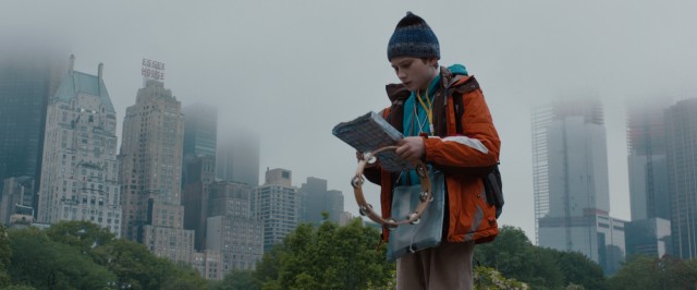 Atop a rock in Central Park with tambourine and map in hand, Oskar Schell (Thomas Horn) plots his search for the lock that fits his dead father's mysterious key.