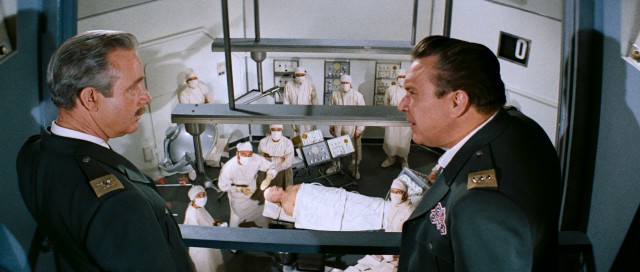 With their clock run out and their scientists prepared to cut, Colonel Donald Reid (Arthur O'Connell) and General Carter (Edmond O'Brien) consider one final way their voyagers might escape safely.