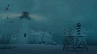 Bernie looks through binoculars in the snowy lighthouse scene of The Finest Hours Blu-ray's unusual (in a good way) main menu.
