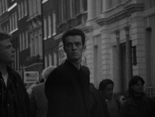 Cobb (Alex Haw) disappears in a crowd in the film's closing shot.