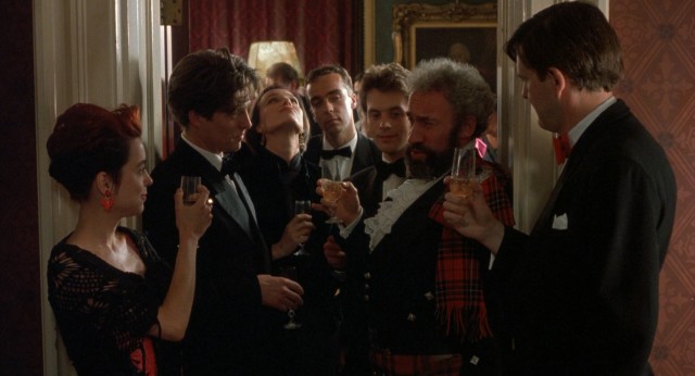 The film's ensemble of seven friends share the screen for a toast at the third wedding, just moments before one of them will suffer a heart attack and die.
