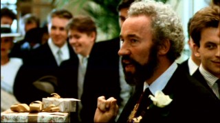 Gareth (Simon Callow) puts his card on a more impressive wedding gift in this deleted scene.