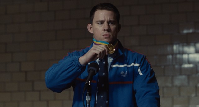 Mark Schultz (Channing Tatum) shows off his Olympic gold medal to grade schooler apathy in "Foxcatcher."