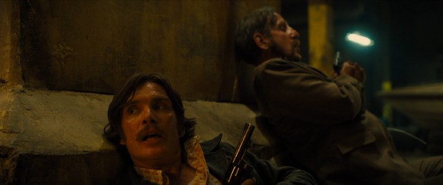 In "Free Fire", 1970s criminals with period-accurate facial hair (including Cillian Murphy and Michael Smiley) crouch and take aim in a Boston warehouse shootout.