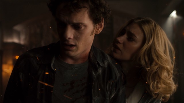 Embers of fire fly as Charley (Anton Yelchin) and Amy (Imogen Poots) try to slay a vampire.