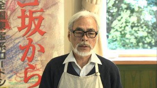 An apron-clad Hayao Miyazaki gives a production update at a press conference following the 2011 Tohoku Earthquake.